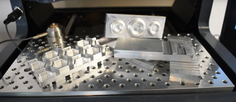 Aluminum parts on a SMW fixture plate inside Tormach xsTECH